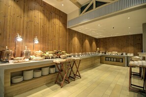A buffet setup with multiple serving stations, wooden panel walls, and a high ceiling with recessed lighting. - Cygnett Collection KK Hotel (Faizabad)