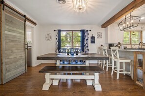 Enjoy meals in this cozy dining area with a wooden table and comfortable seating for all.