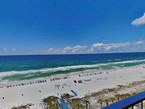 A beach with white sand, a clear blue sky, and the ocean. - Summit Beach Resort #1119 | Views + Pool! (Panama City Beach)