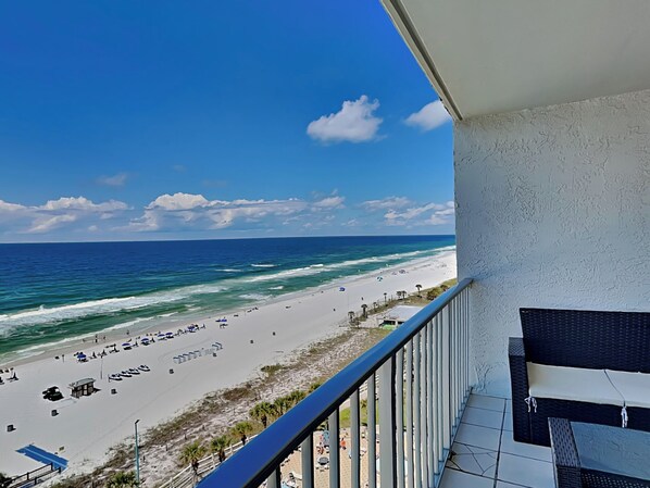 A balcony with a view of a beach and ocean. - Summit Beach Resort #1119 | Views + Pool! (Panama City Beach)