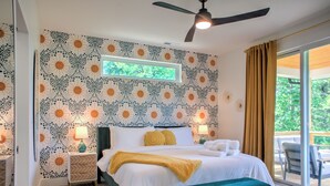 A bedroom with a bed, bedside tables, a ceiling fan, and a window with curtains. - Hops and Dreams by Carolina Mornings | Hot Tub, Mtn Views⛰️+Biltmore Pass (Leicester)