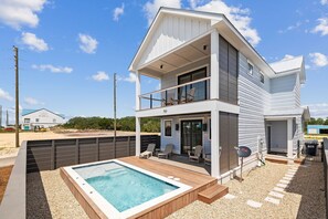 A two-story house with a balcony, a swimming pool, and a covered patio area. - Knee Deep: 4 Bedrooms, Private Pool, Close to Restaurants (St. George IUsland)