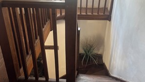 A wooden staircase with a handrail, leading to an upper floor. - Coastal South Devon cottage near Thurlestone and Salcombe (Kingsbridge)