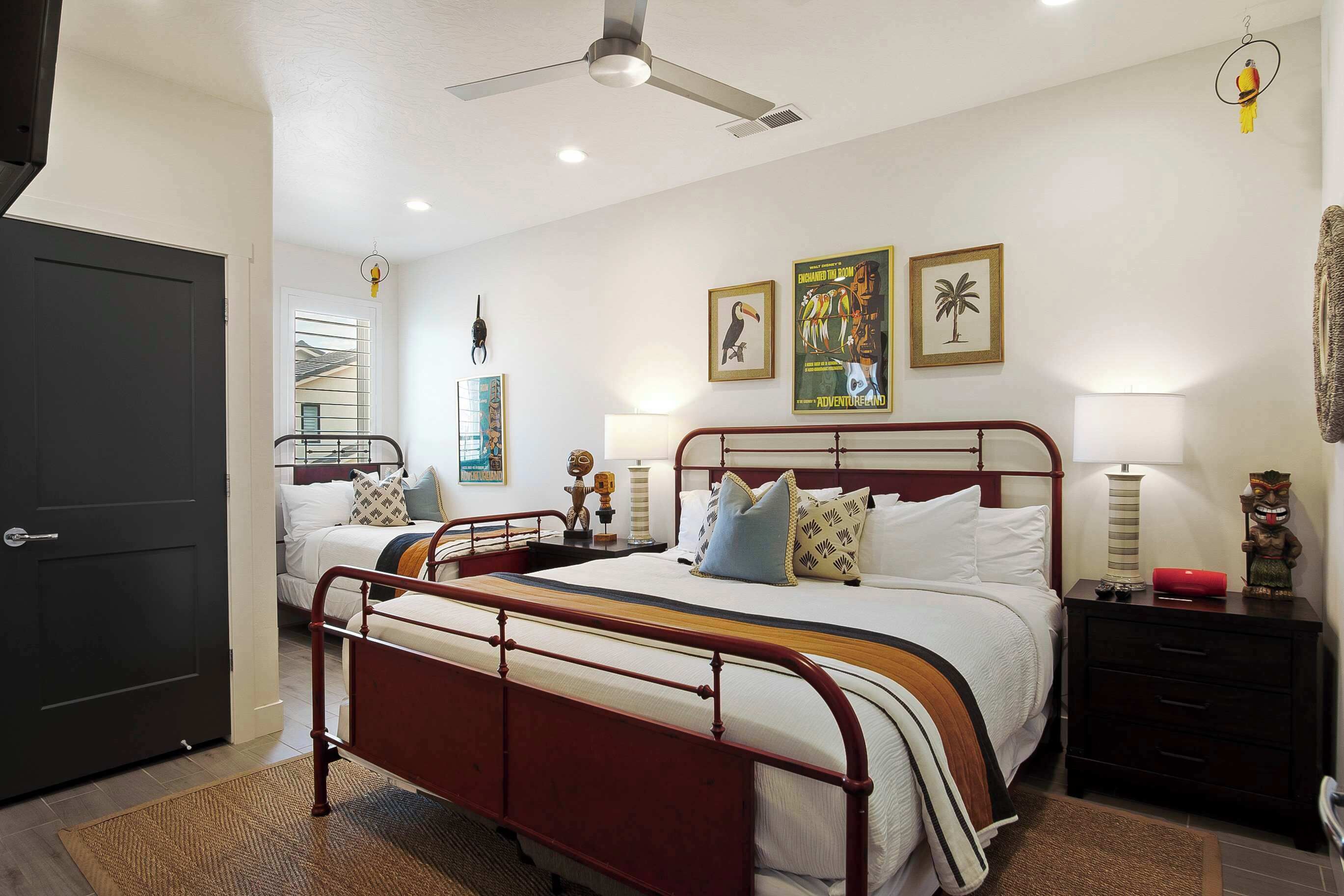 A bedroom with a bed, bedside tables, a wardrobe, and a ceiling fan.