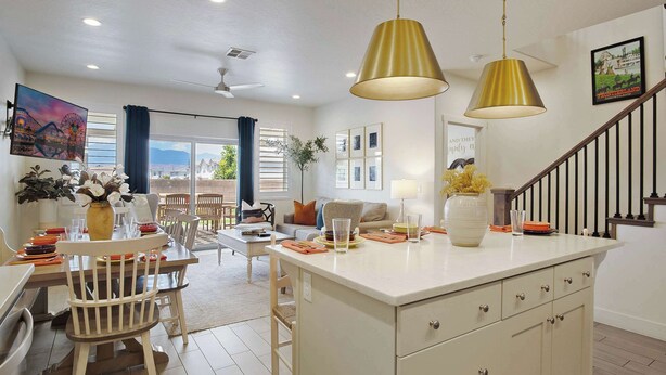 A modern kitchen with a central island, pendant lighting, and a dining area with a view. - New Listing Be Our Guest in Utah (Washington)