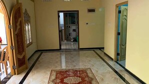 A hallway with a patterned floor, a red carpet, and a decorative ceiling. - A Stunning, Newly Built 3-bedroom Property to Rent (Iyakachchi)