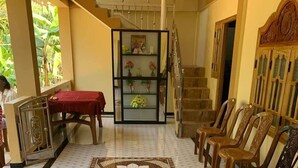 A spacious hallway with a patterned floor, a staircase, and a seating area with chairs. - A Stunning, Newly Built 3-bedroom Property to Rent (Iyakachchi)