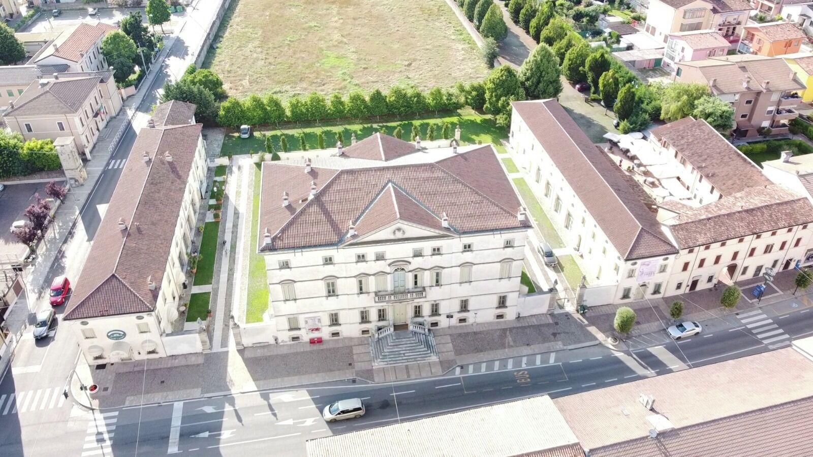 A large building with a central courtyard, surrounded by smaller buildings.