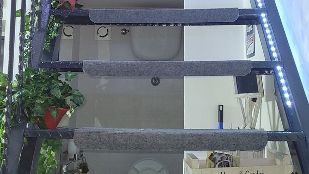 A staircase with LED lights, a tree mural, and a 'Home & Garden' sign. - In the heart of Naples. Pets allowed. Stroller and crib available free of charge. (Napoli)