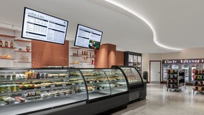 A bakery display case in a modern cafe with menu boards above. - Dream Las Vegas Retreat Steps from the Strip! (Las Vegas)