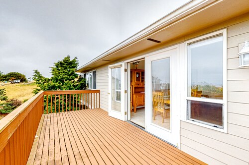 Peek-a-boo ocean view home with outdoor living space, W/D, and balcony