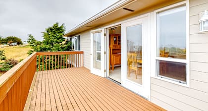 Peek-a-boo ocean view home with outdoor living space, W/D, and balcony