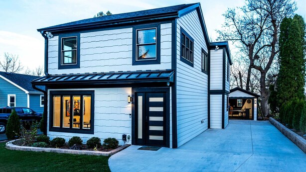 A two-story house with a front porch, a garage, and a small attached structure. - Gatsby Theme Near Downtown w Game Room, EV Charger (Lake Geneva)