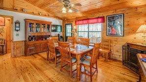 A wooden cabin interior with a dining area, wooden ceiling, and a fireplace. - Blueridge Bunk House Wrap-around Deck! (Blue Ridge)