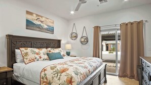 A bedroom with a bed, a nightstand, a lamp, and a view of the outside. - By the Sea Ocean Vibes in the Mountains! (Washington)