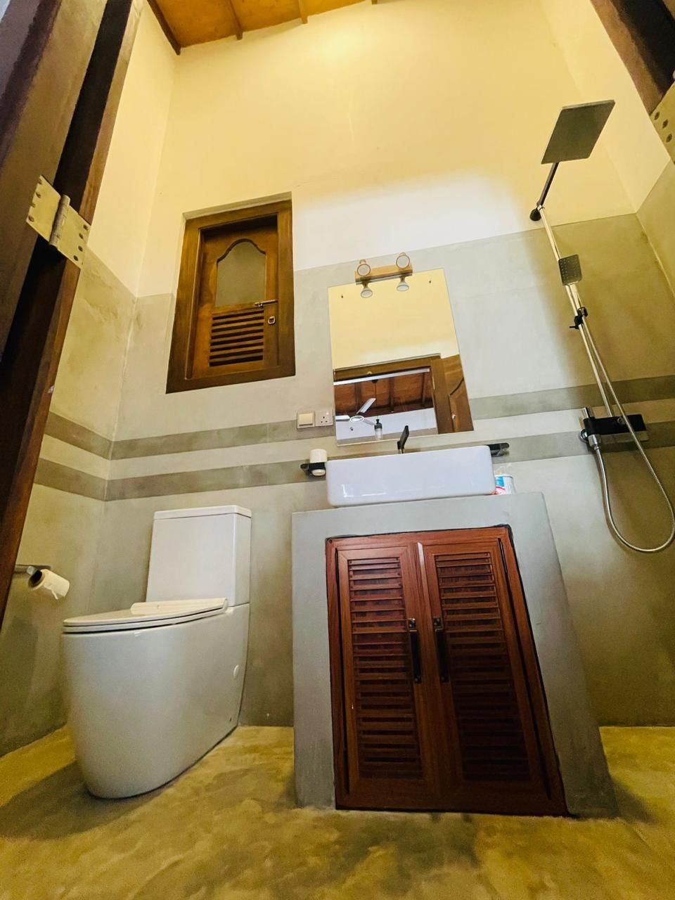 A bathroom with a toilet, a sink, and a shower.