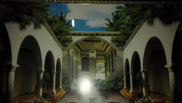 A courtyard with a fountain, arches, and potted plants. - Christy Mwila Chisenga (Kitwe)