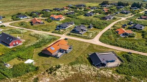 An aerial view of a residential area with houses, roads, and a body of water in the background. - "Gottfreda" - 330m to the fjord by Interhome (Hvide Sande)