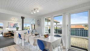 A spacious kitchen with a dining area, large windows, and a view of the outside. - "Gottfreda" - 330m to the fjord by Interhome (Hvide Sande)