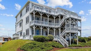 A multi-story building with a balcony and staircase.