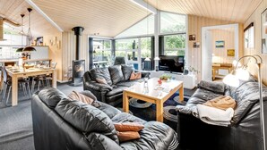 A modern interior with a dining area, seating, and a fireplace.