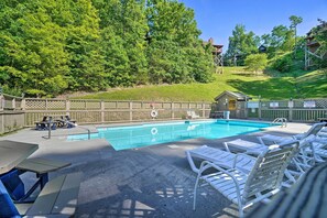Relax by the pool surrounded by lush greenery and enjoy easy access with the pool ladder.