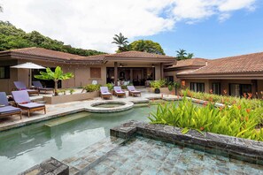 A pool area with lounge chairs, a hot tub, and tropical plants. - Hale Nene Pool, Spa Tub & Ocean Views! (Kailua-Kona)