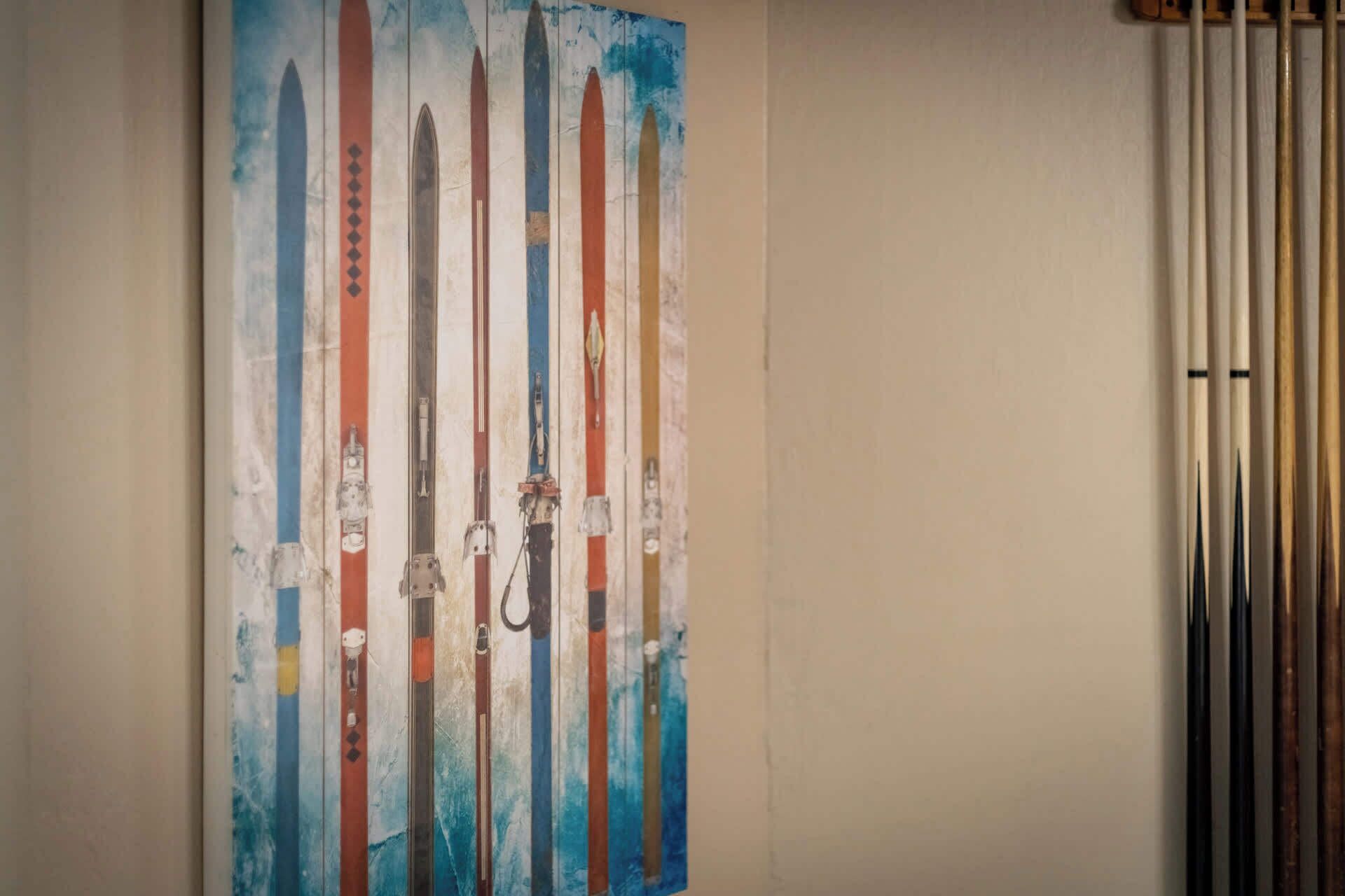 A wall with a painting of skis.