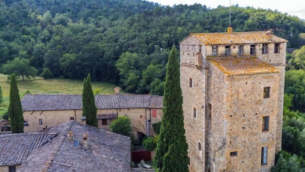 A stone building with a tower, surrounded by trees and a hilly landscape. - La Torre by Interhome (Sovicille)