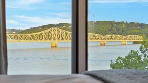 A view of a bridge over water with a forested hill in the background. - Enjoy Lakeside Fun Lakeview At Table Rock! (Kimberling City)