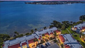 A coastal hotel with multiple buildings, a marina, and a view of the sea.