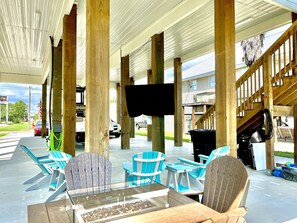 Enjoy dining or socializing in this outdoor seating area with a covered roof and comfortable seating.