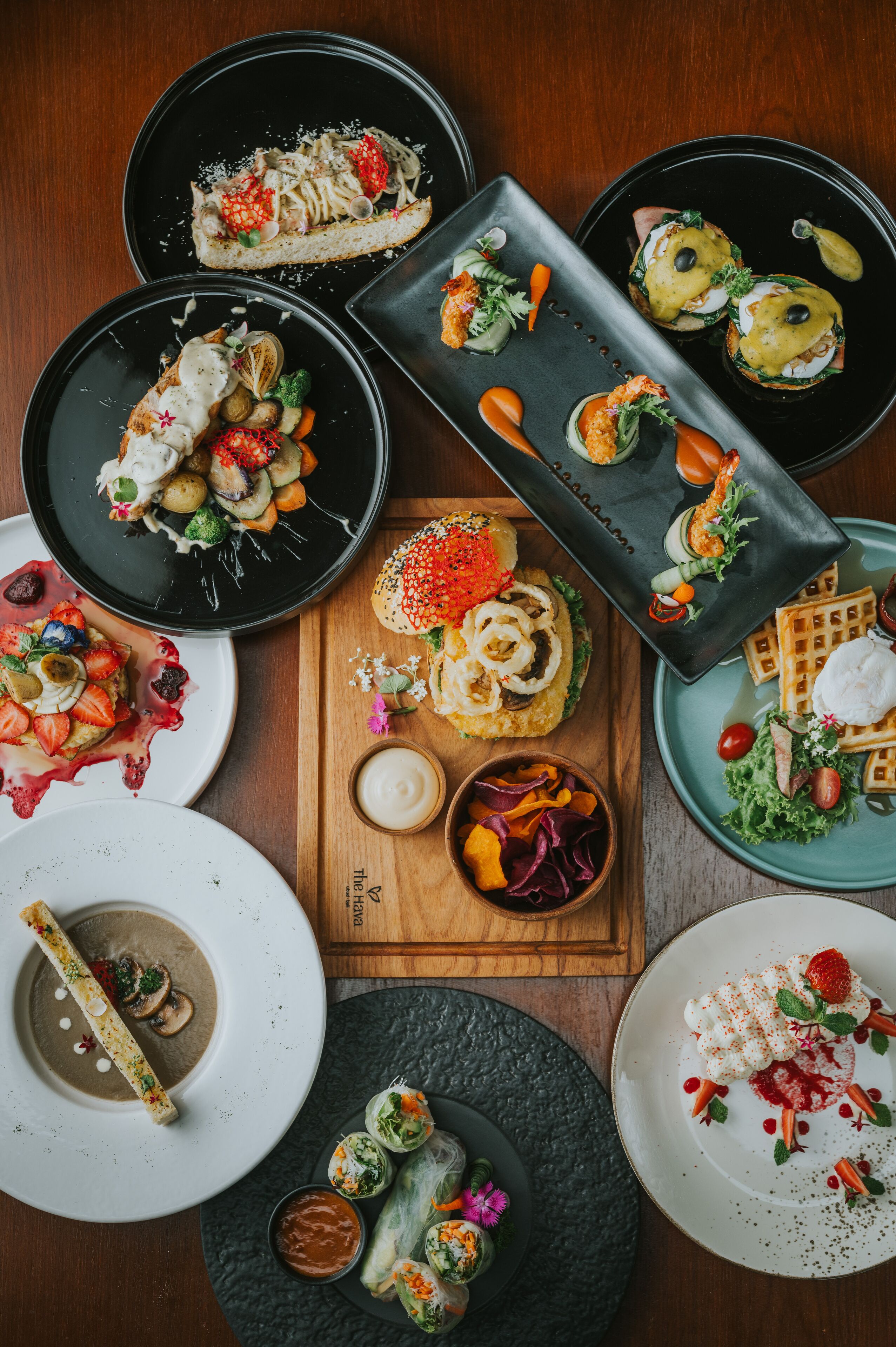 A variety of dishes on multiple plates and a wooden board, suggesting a dining setting.