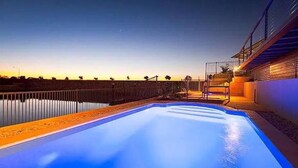 A swimming pool at dusk with a view of the horizon. - Gecko - On the Marina With Pool & Private Jetty, 4 Kestrel Place, Exmouth (Exmouth)