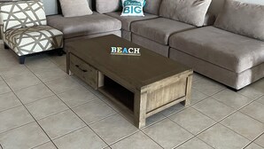 A modern living room with a sectional sofa, a patterned armchair, a wooden coffee table, and a painting on the wall. - Gecko - On the Marina With Pool & Private Jetty, 4 Kestrel Place, Exmouth (Exmouth)