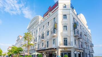 A historic hotel with a classic European architectural style, featuring a prominent dome and symmetrical facade.