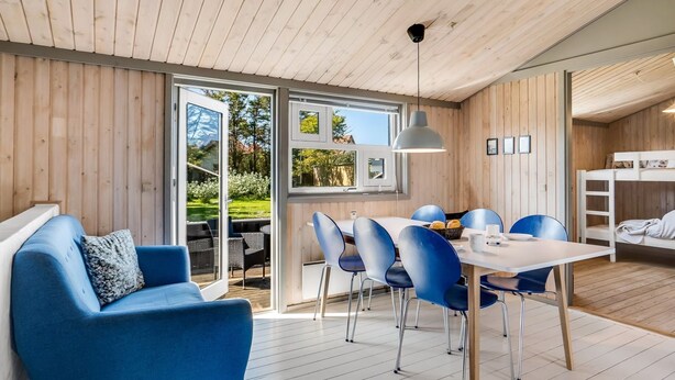 A modern interior with a dining area, a sofa, and a bunk bed. - "Lazorka" - 450m from the sea by Interhome (Løkken)