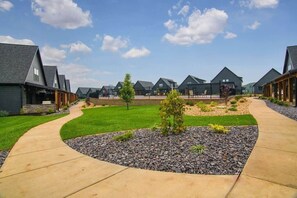 A residential area with modern houses, a curved driveway, and well-maintained lawns.