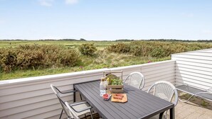 An outdoor patio with a table set for two, overlooking a rural landscape. - "Drita" - 2.3km from the sea by Interhome (Rømø)