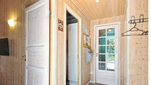 A wooden interior with a door labeled "Garage," a coat rack, and a tiled floor. - "Thordo" - 2.4km from the sea by Interhome (Rømø)