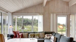 A cozy living room with a grey sofa, a small table, and a patterned rug. - "Annemia" - 200m from the sea by Interhome (Thisted)