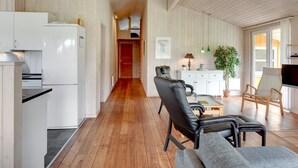 A spacious living area with a wooden floor, a dining table, a sofa, and a TV. - "Annemia" - 200m from the sea by Interhome (Thisted)