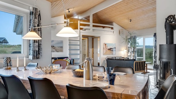 A modern kitchen with a large island, wooden ceiling, and a view of the outdoors. - "Palli" - 600m from the sea by Interhome (Thisted)