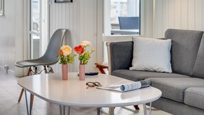 A modern living room with a round table, a grey sofa, and a large window. - "Ibo" - 900m from the sea by Interhome (Thisted)