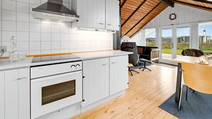 A modern kitchen with white cabinetry, a built-in oven, and a wooden ceiling. - "Olesia" - 250m from the sea by Interhome (Harboøre)