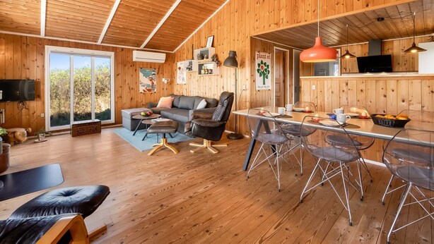 A wooden interior with a sofa, dining table, chairs, and a TV. - "Brigit" - 200m from the sea by Interhome (Harboøre)