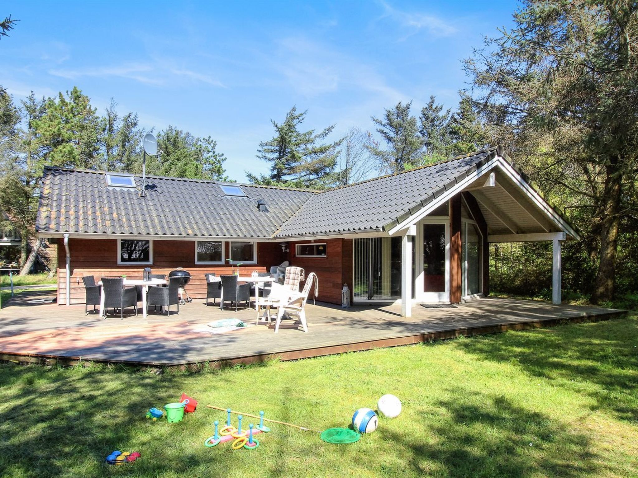 A house with a patio, outdoor furniture, and a covered area.