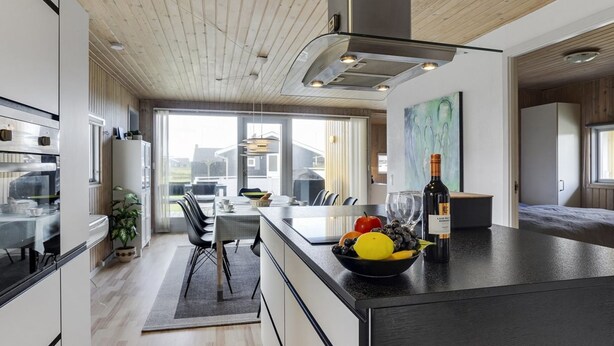 A modern kitchen with a large island, stainless steel appliances, and a view to the outside. - "Hebba" - 300m from the sea by Interhome (Harboøre)