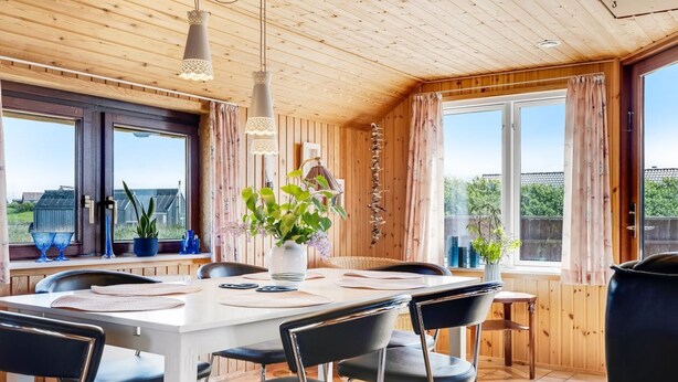 A dining area with a wooden ceiling, large windows, and a view of the outdoors. - "Beatrice" - 150m from the sea by Interhome (Lemvig)