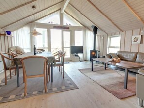 Relax in this spacious loft-style living area with a dining table, comfortable sofa, and fireplace.